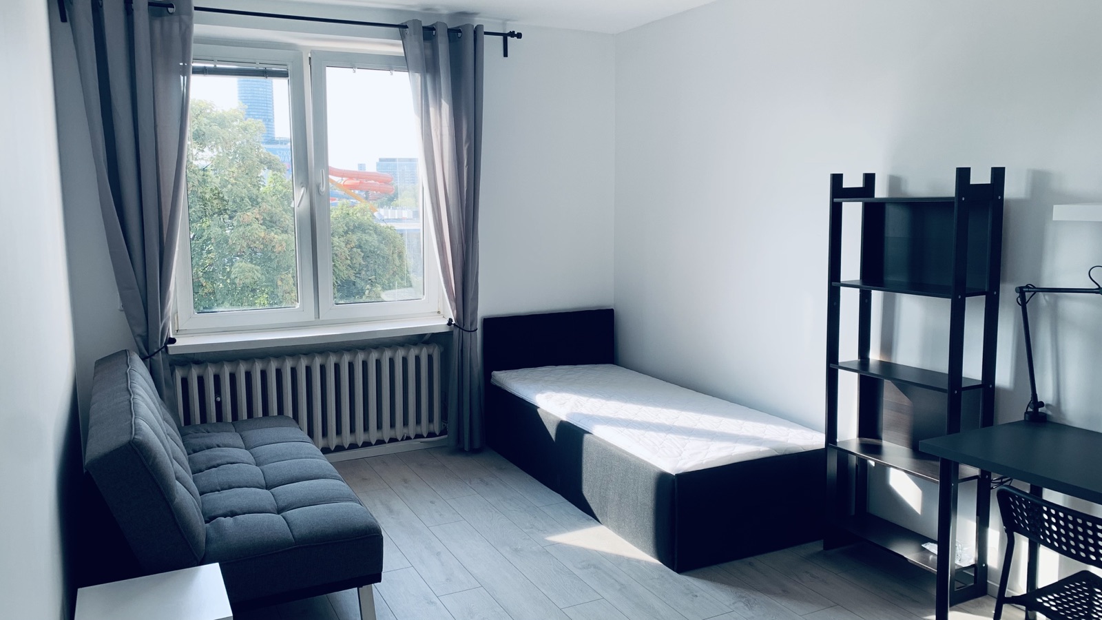 Room overview showing bed, sofa bed and desk