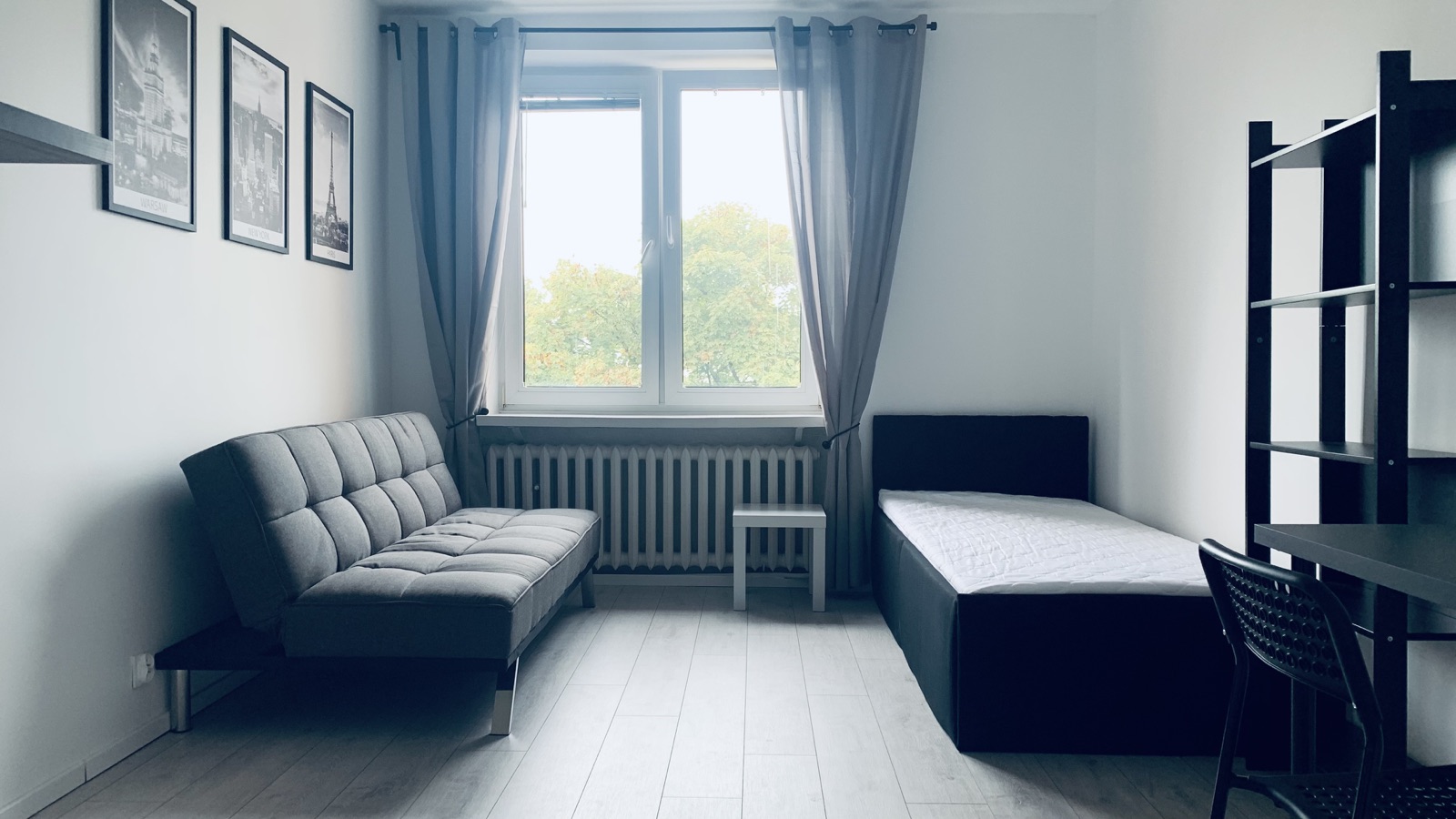 Room view with sofa bed, bed and window
