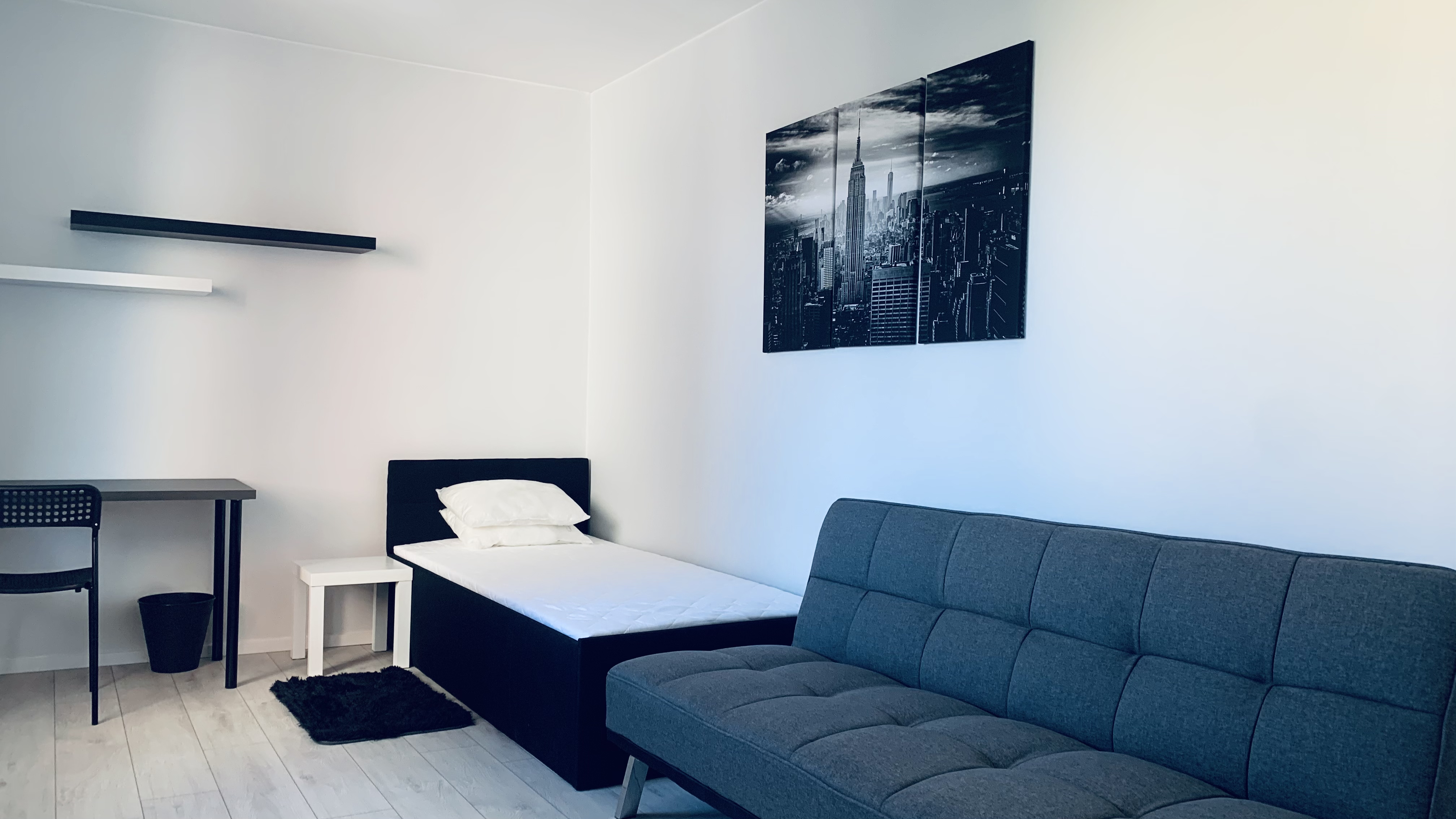 Bed and sofa in Borowska room #2