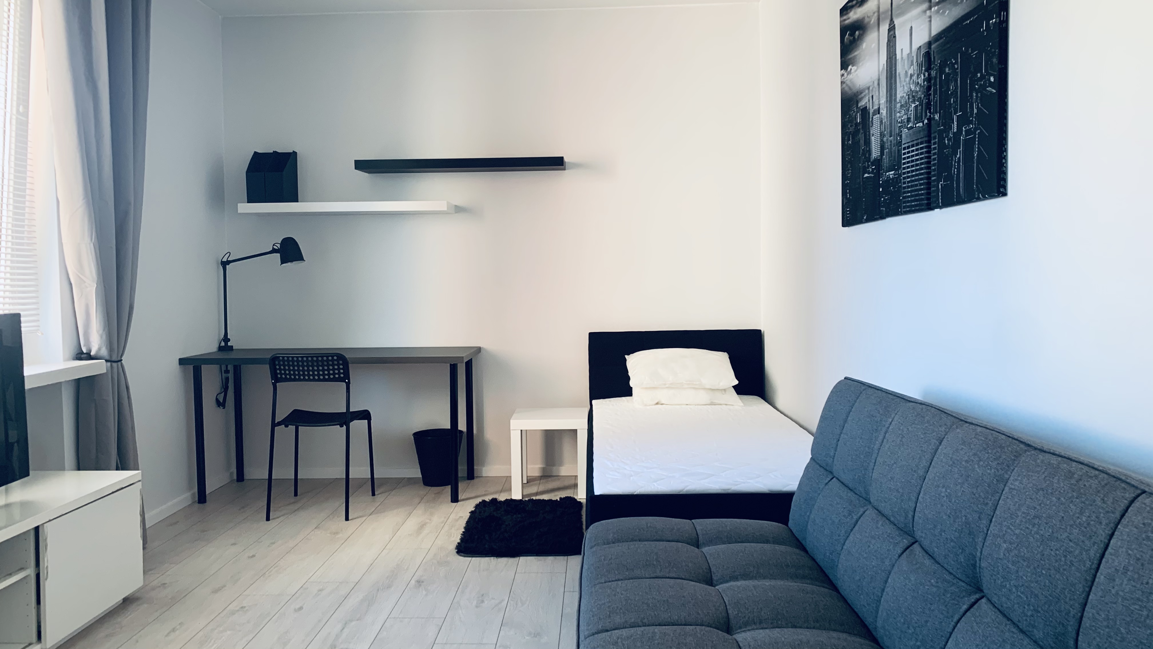Workspace and bed in Borowska room #2