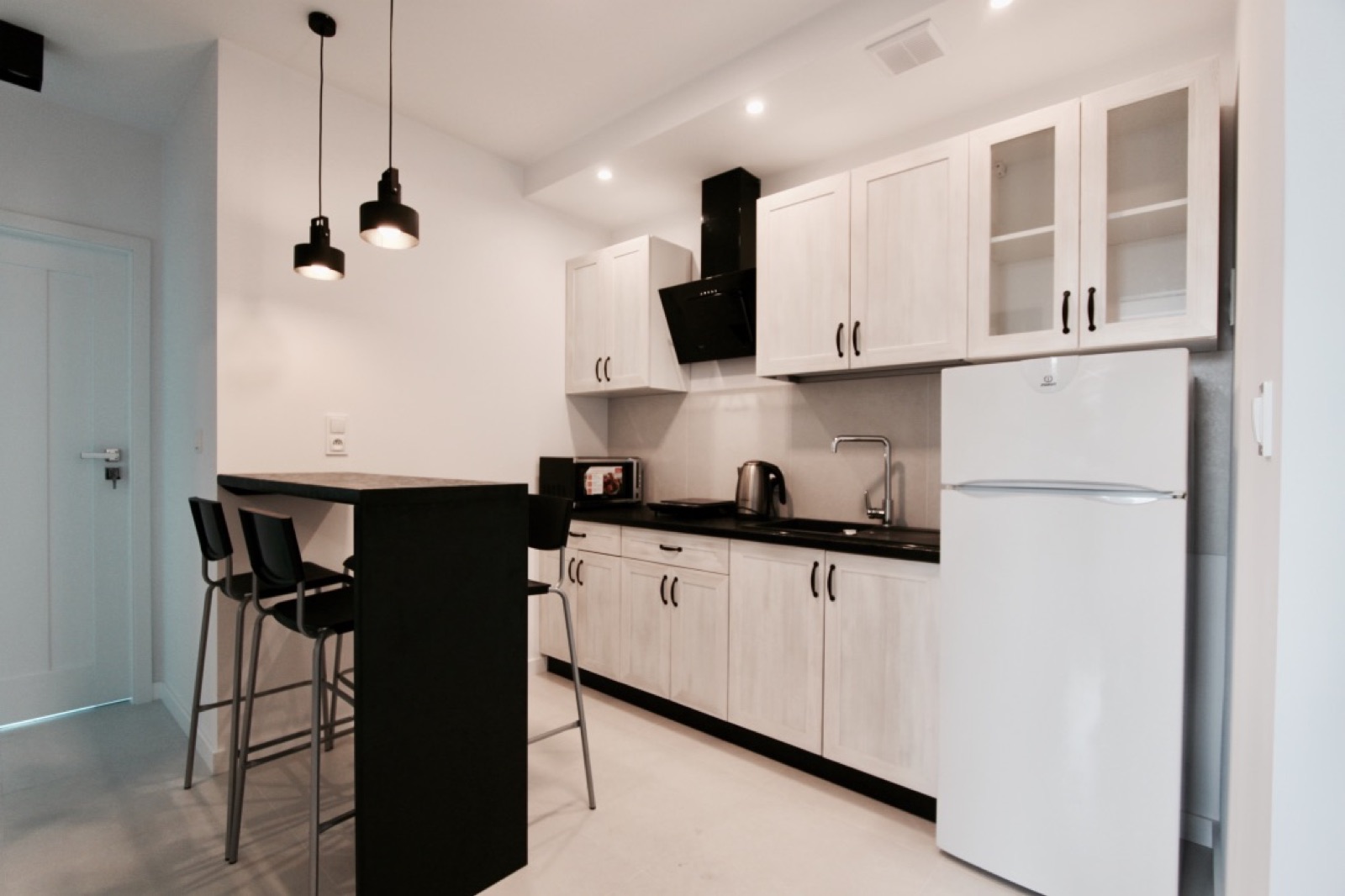 Full view of the shared kitchen, fridge and breakfast bar
